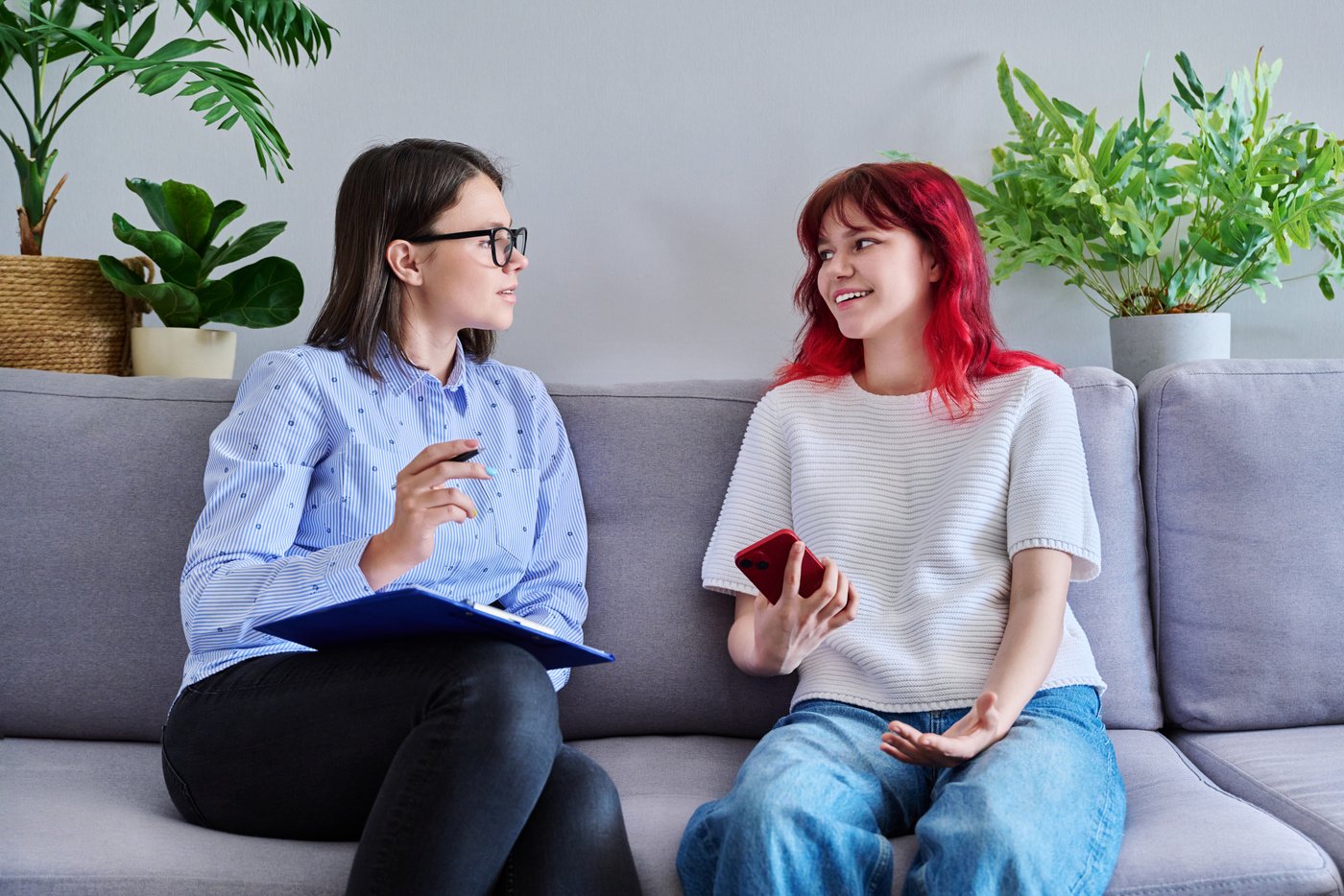 Psychologist Counseling Teenage Female, Individual in Doctors Office.